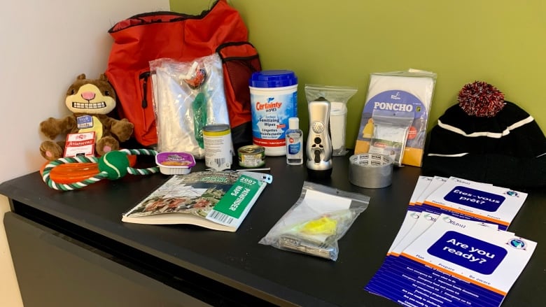 Items for an emergency kit are seen on a table.