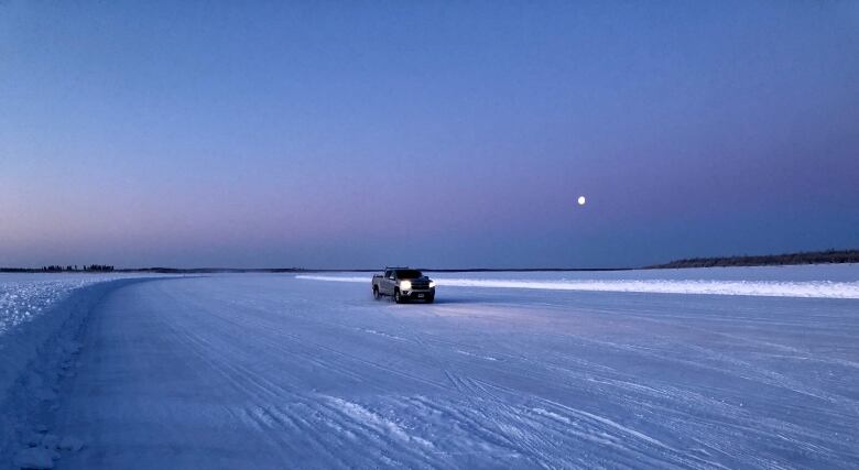 A truck drives on a frozen lake, 