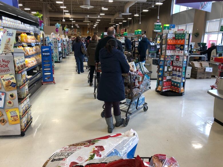 Shopping carts in line at grocery store.