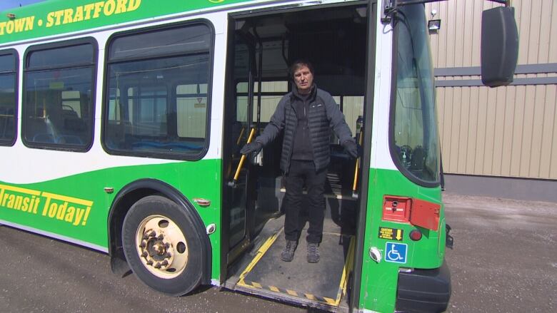 Mike Cassidy walking down the ramp of an accessible bus.