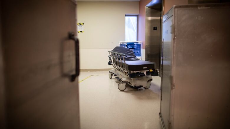 A hospital bed, as seen from the hallway.