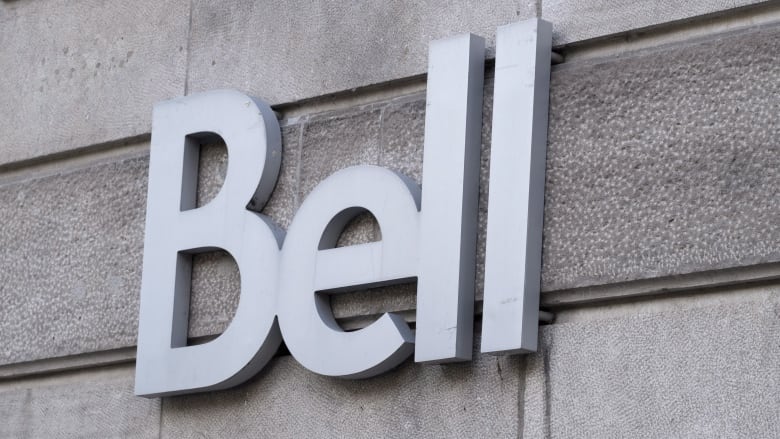 A logo for Bell is affixed to the side of a building.