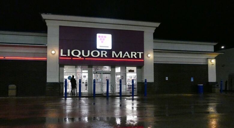 The exterior of a Manitoba Liquor Mart building is shown outside in the evening.