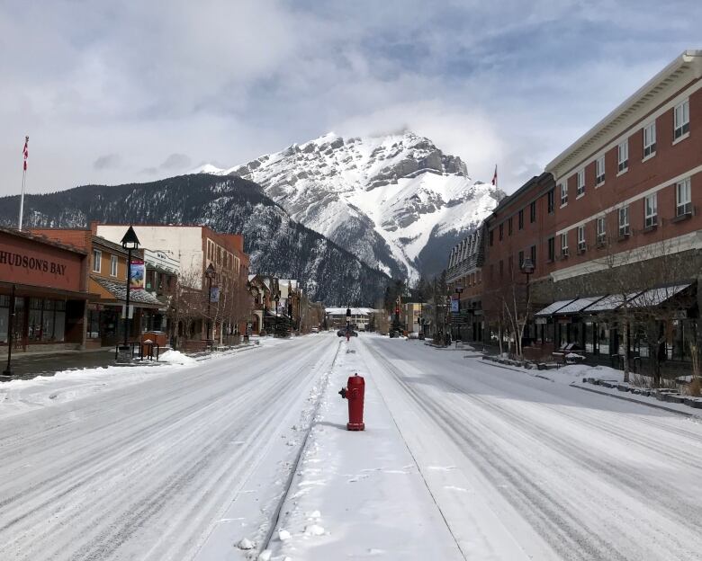 a picture of a snowy road with a mountain in the background