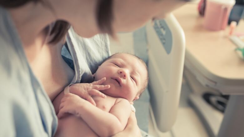 A baby and mother are seen in hospital in this stock photo.