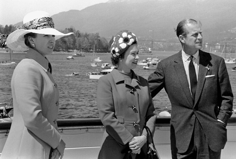 Three people on deck of boat