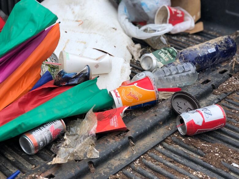 A pile of trash and empty beer cans.