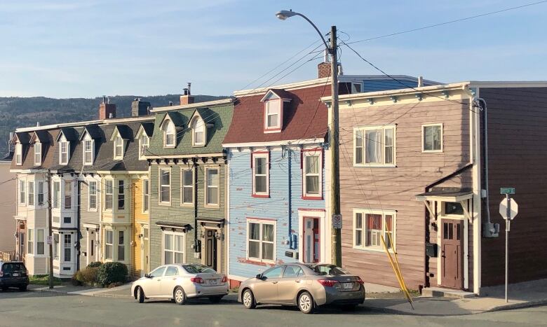 A row of colourful houses in downtown St. John's on a clear, sunny day.