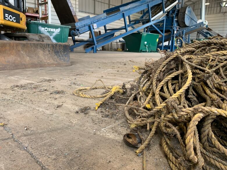 A pile of dirty old rope next to equipment.