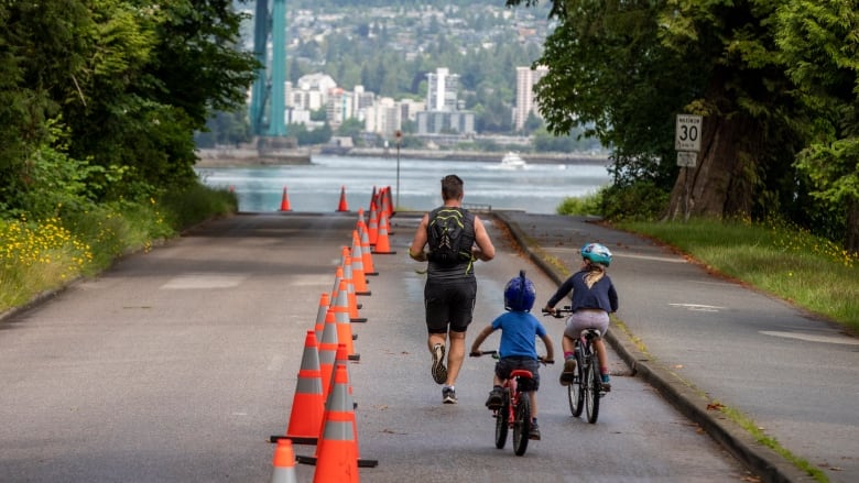 Bicycles cycle along Stanley Park. 