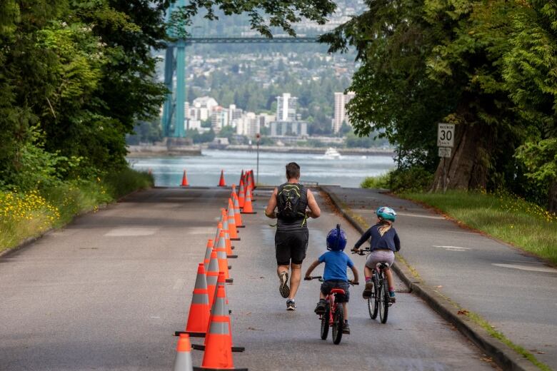 Bicycles cycle along Stanley Park. 