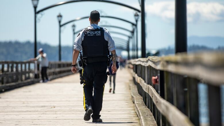 A man walks on a pier.