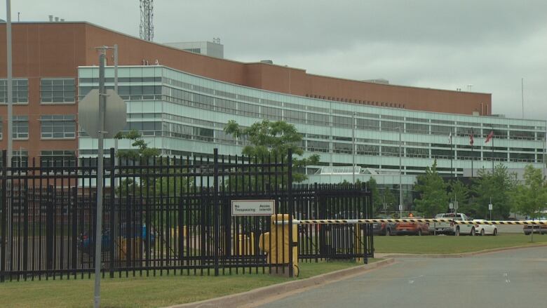 The gated entrance to a large building that is Nova Scotia RCMP's headquarters. 