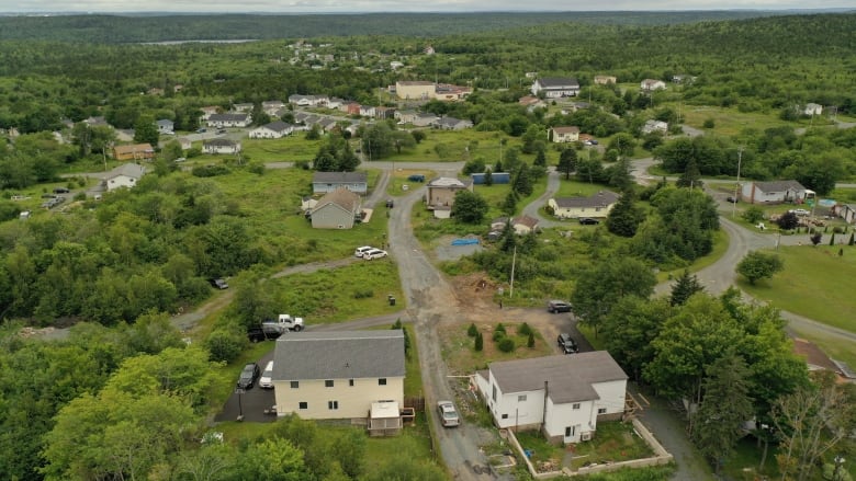 An overhead view of part of North Preston shows green trees, roads and homes