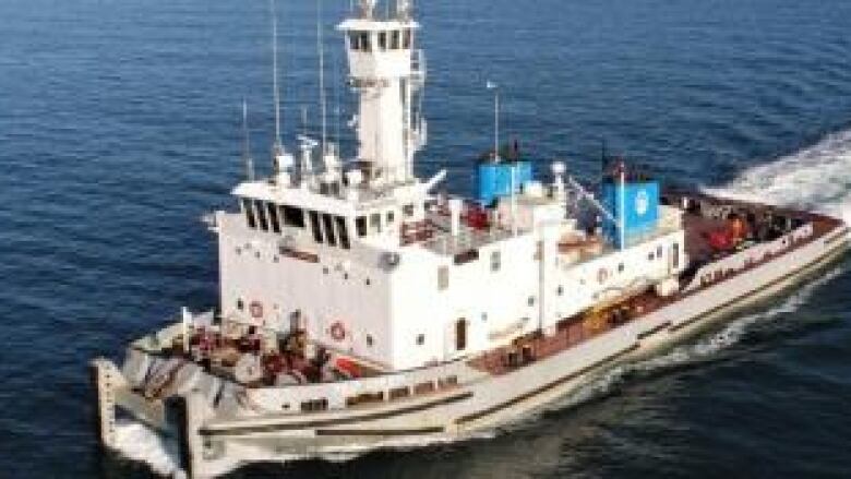 A tug boat navigates the open water.