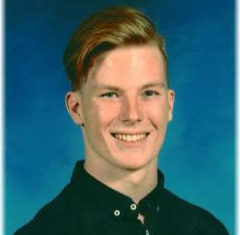 A man in front of a blue background