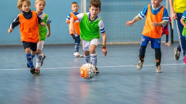 Children run for a ball at a soccer game.