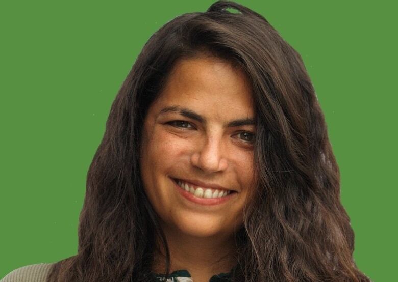 Head and shoulders shot of a smiling woman with long, dark hair.