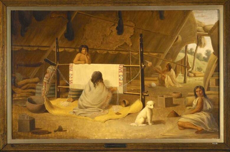 A painting shows four Indigenous people, one of them weaving a blanket, and a small white dog. 