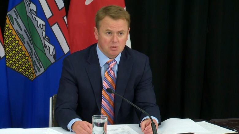 A man sits at a podium.