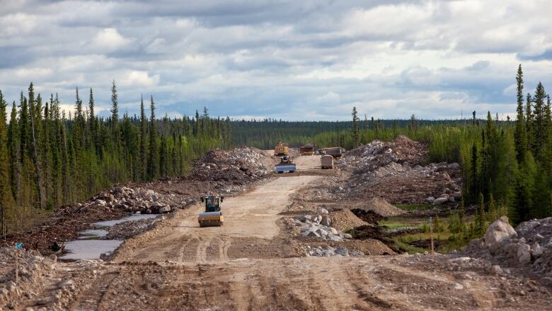 A construction vehicle on the Whati road as it's under construction. 