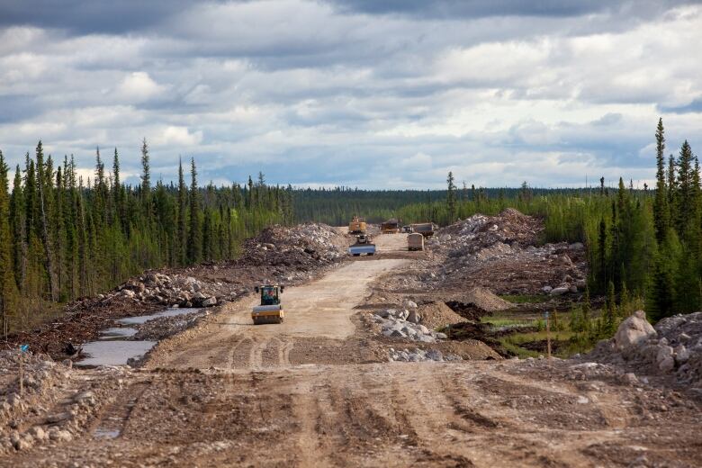 A construction vehicle on the Whati road as it's under construction. 