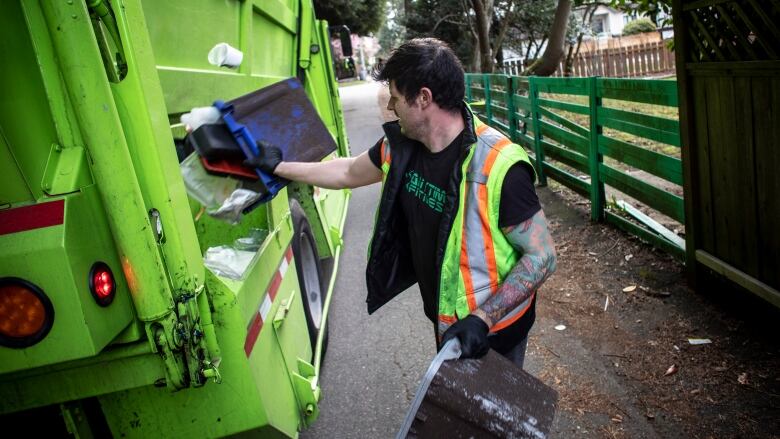 Clay Danyluk, with GFL Environmental Waste management company is pictured on his route in Vancouver, British Columbia on Friday, April 3, 2020. 