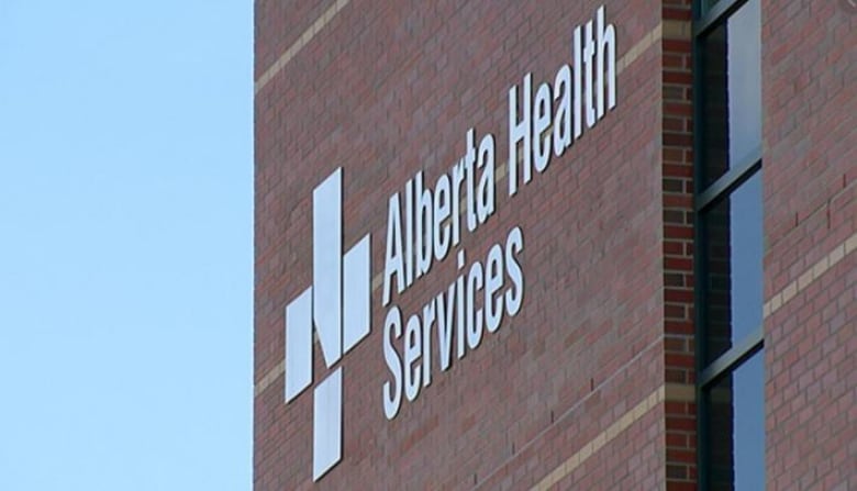 An Alberta Health Services sign is seen on a building.