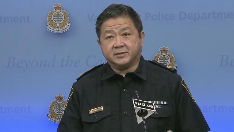 Vancouver Police Deputy Chief Const. Howard Chow appears at a microphone with a Vancouver Police Department backdrop.