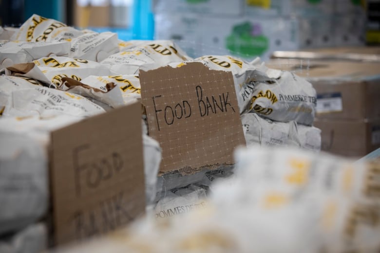 A close up shot of food wrapped on a table. Small cardboard signs in front of it say 