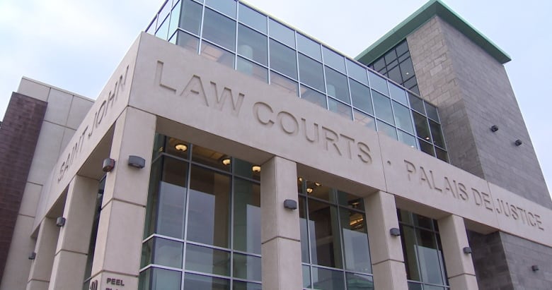 A large grey building with lots of windows and the words 'Law Courts' engraved.