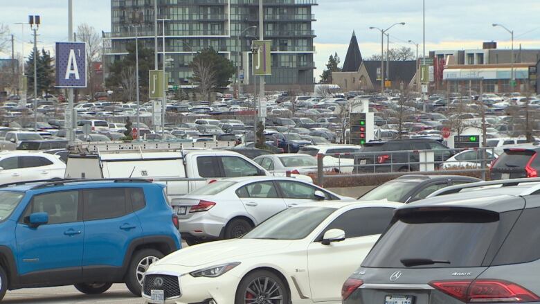 Rows of cars in a packed parking lot. 