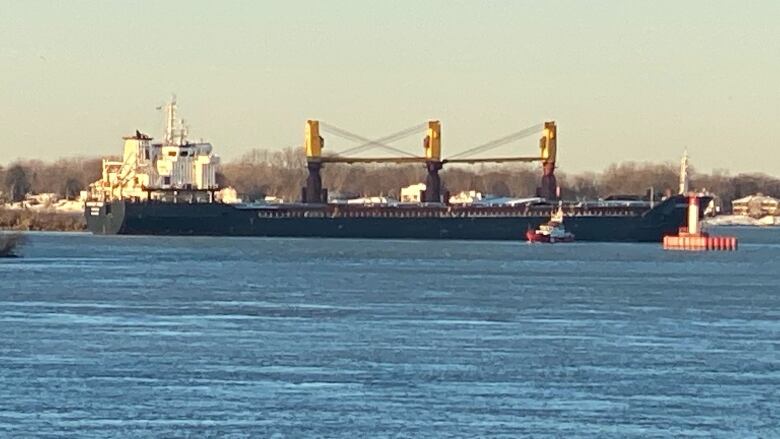 A large ship crosses the Detroit River. 