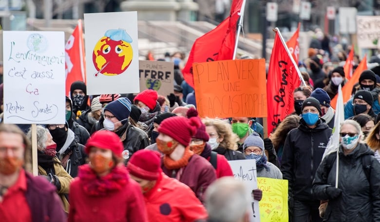 People take part in a climate change protest in Montreal, Saturday, Nov. 21, 2020, as the COVID-19 pandemic continues in Canada and around the world.