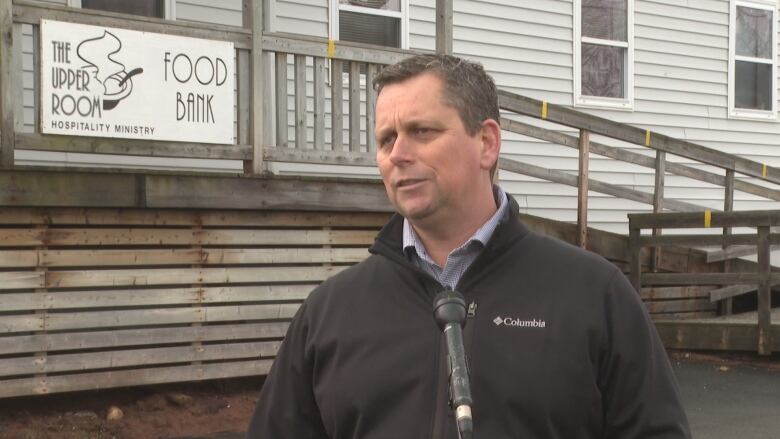 Mike MacDonald stands in front of Upper Room food bank 