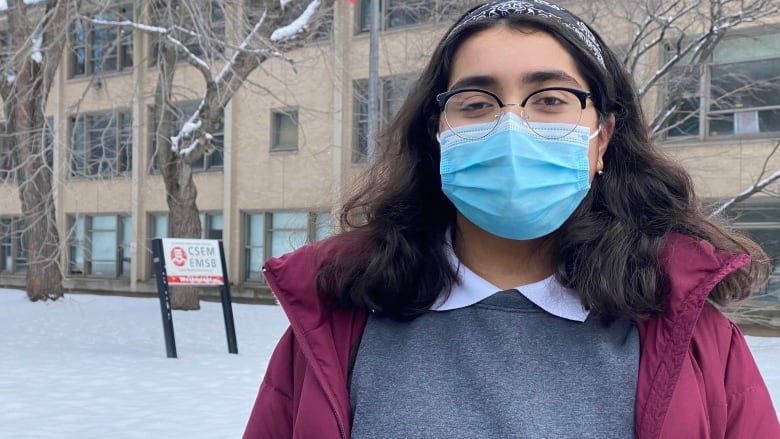 a young woman with glasses and a mask