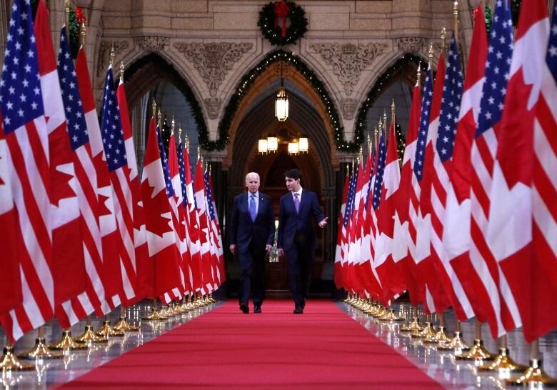 Prime Minister Justin Trudeau and U.S. vice-president Joe Biden walk down the Hall of Honour on Parliament Hill in Ottawa on Friday, December 9, 2016. 