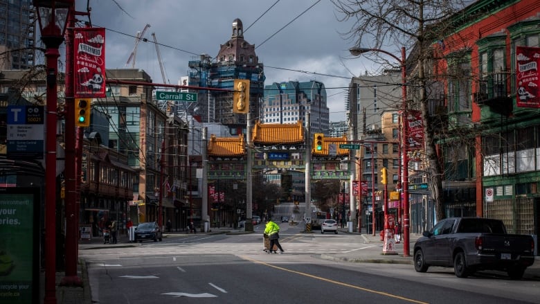 A city worker crosses the street in the midst of Vancouver's historic Chinatown neighbourhood.