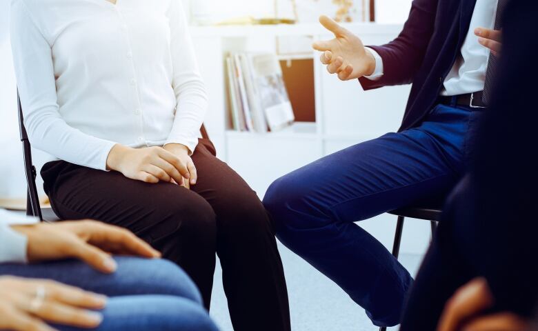 Anonymous group of people talking in a circle. 