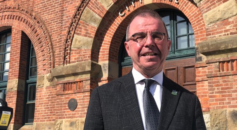 Charlottetown Mayor Philip Brown in front of city hall on a sunny day.