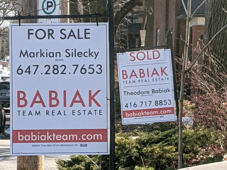 For Sale and Sold signs are shown outside a home.