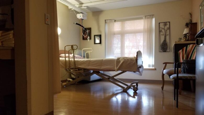 A nursing home bed, as seen from the doorway.