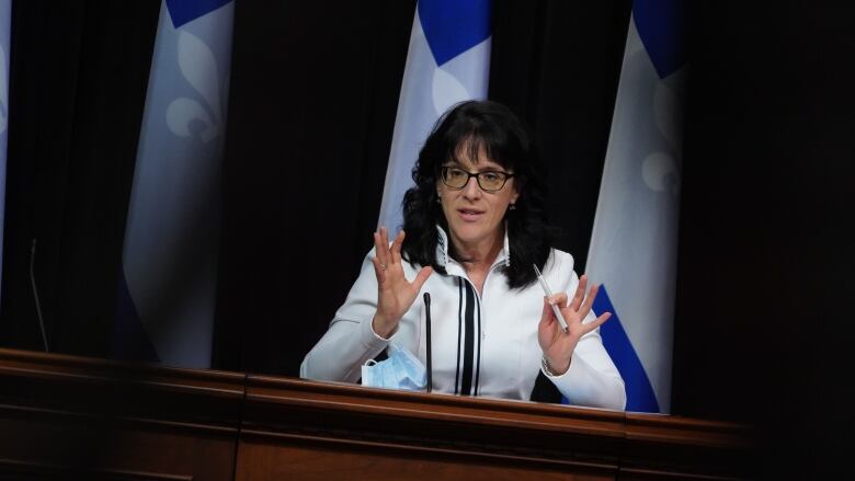 A woman stands behind a podium. 