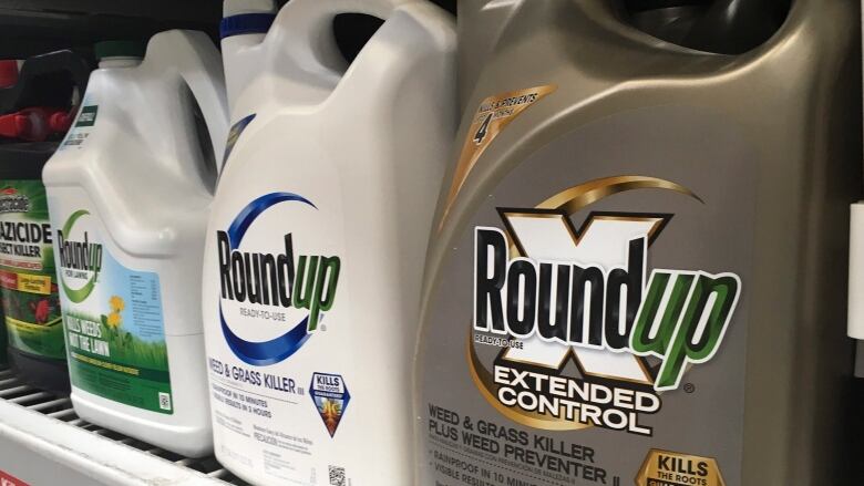 Bottles of Roundup on a shelf.