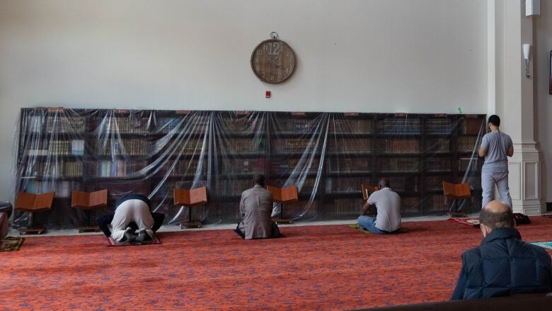 People are pictured praying inside Mosque of Mercy during Ramadan.  