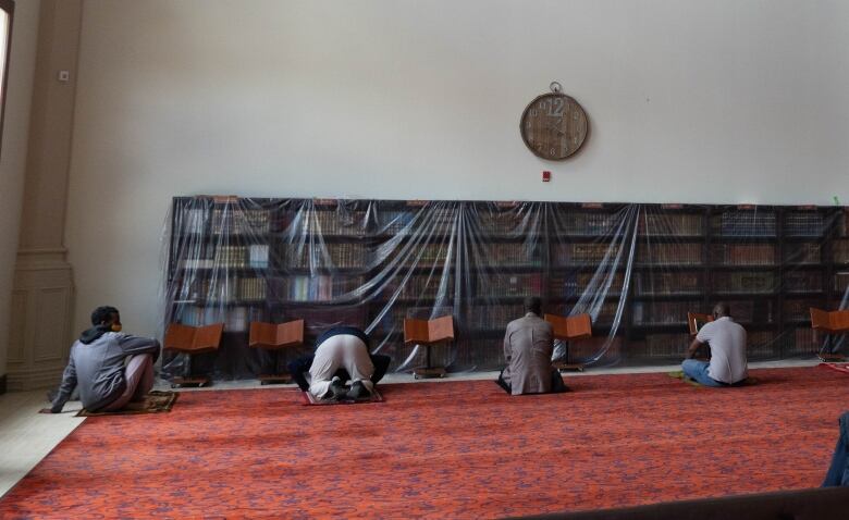 People are pictured praying inside Mosque of Mercy during Ramadan.  