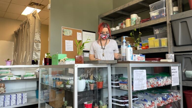 A person stands at the counter inside the Pounds Project in Prince George, B.C. 