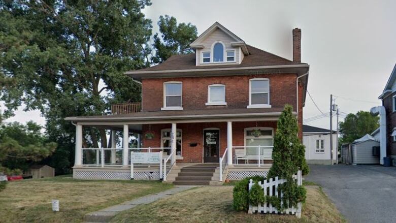 An old home with a green lawn.