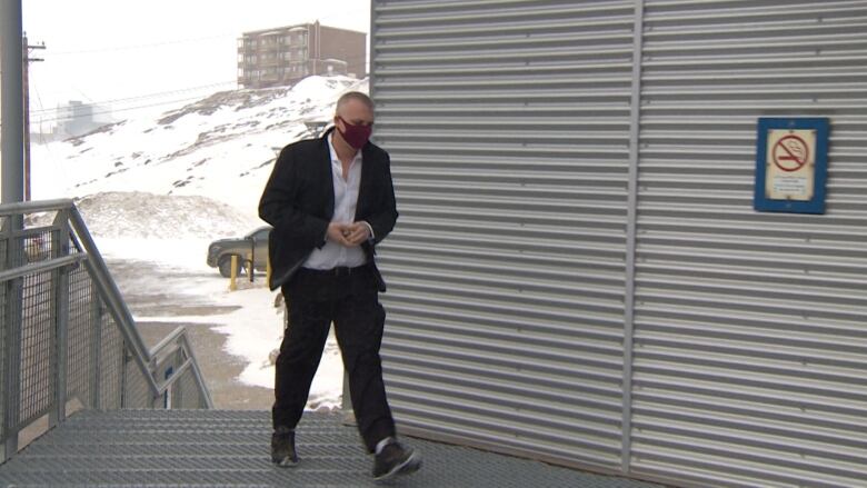 A man walks up the steps of Nunavut's courthouse in Iqaluit. 