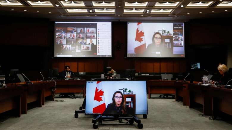 Katie Telford, Chief of Staff to Canada's Prime Minister Justin Trudeau, appears on a screen as she attends a House of Commons defence committee.